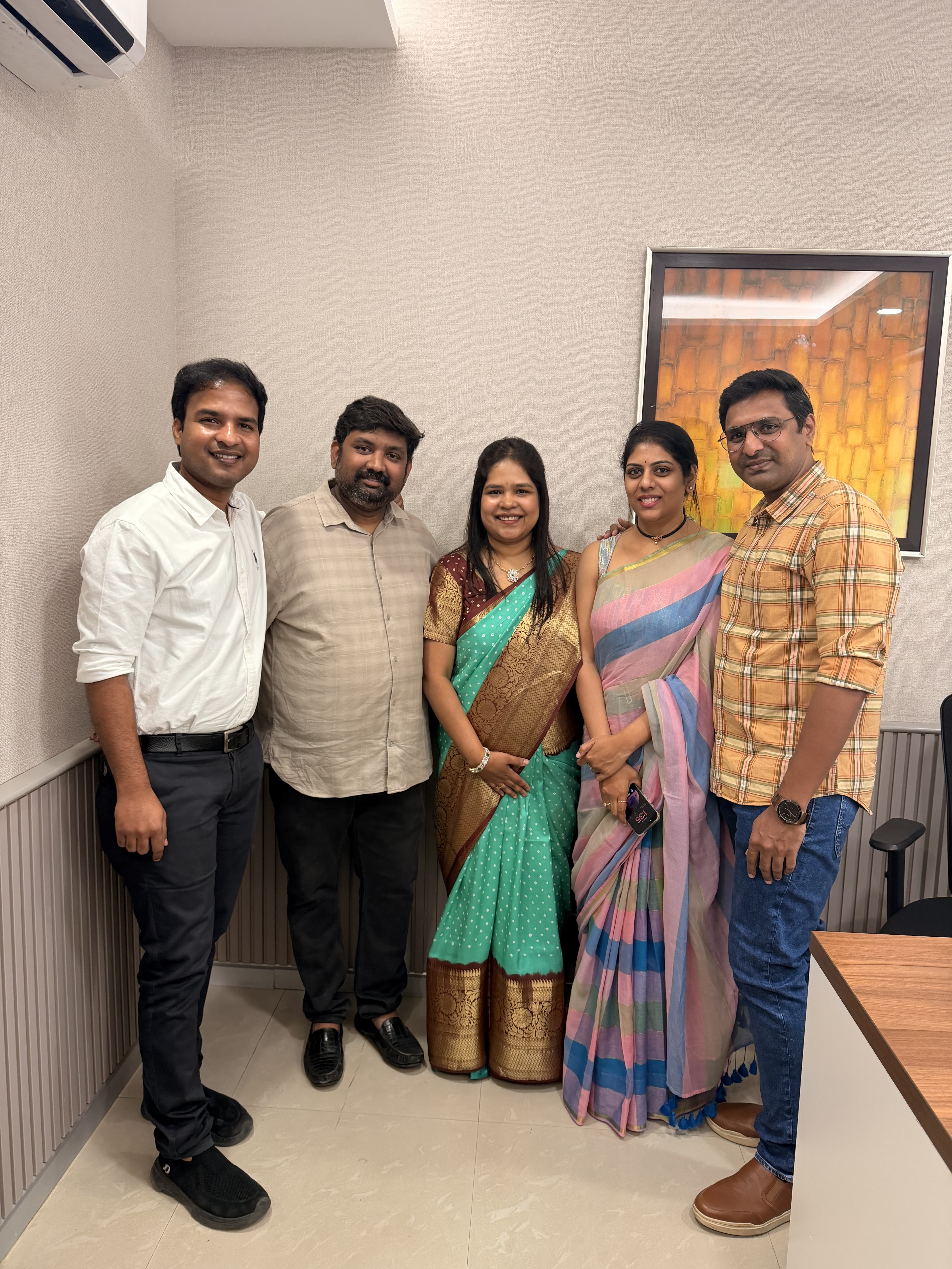 Two couples with Dr. Vellala at the clinic