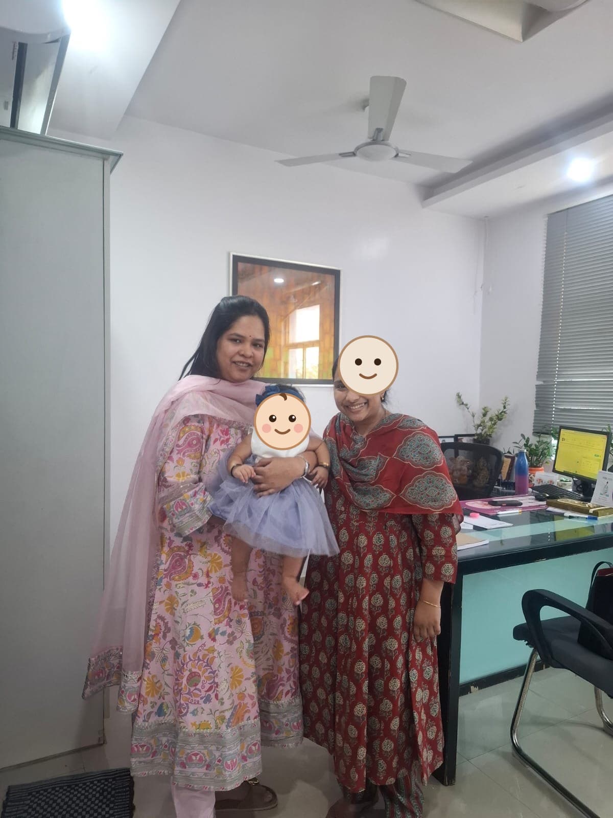 A mother and Dr. Vellala with a baby girl