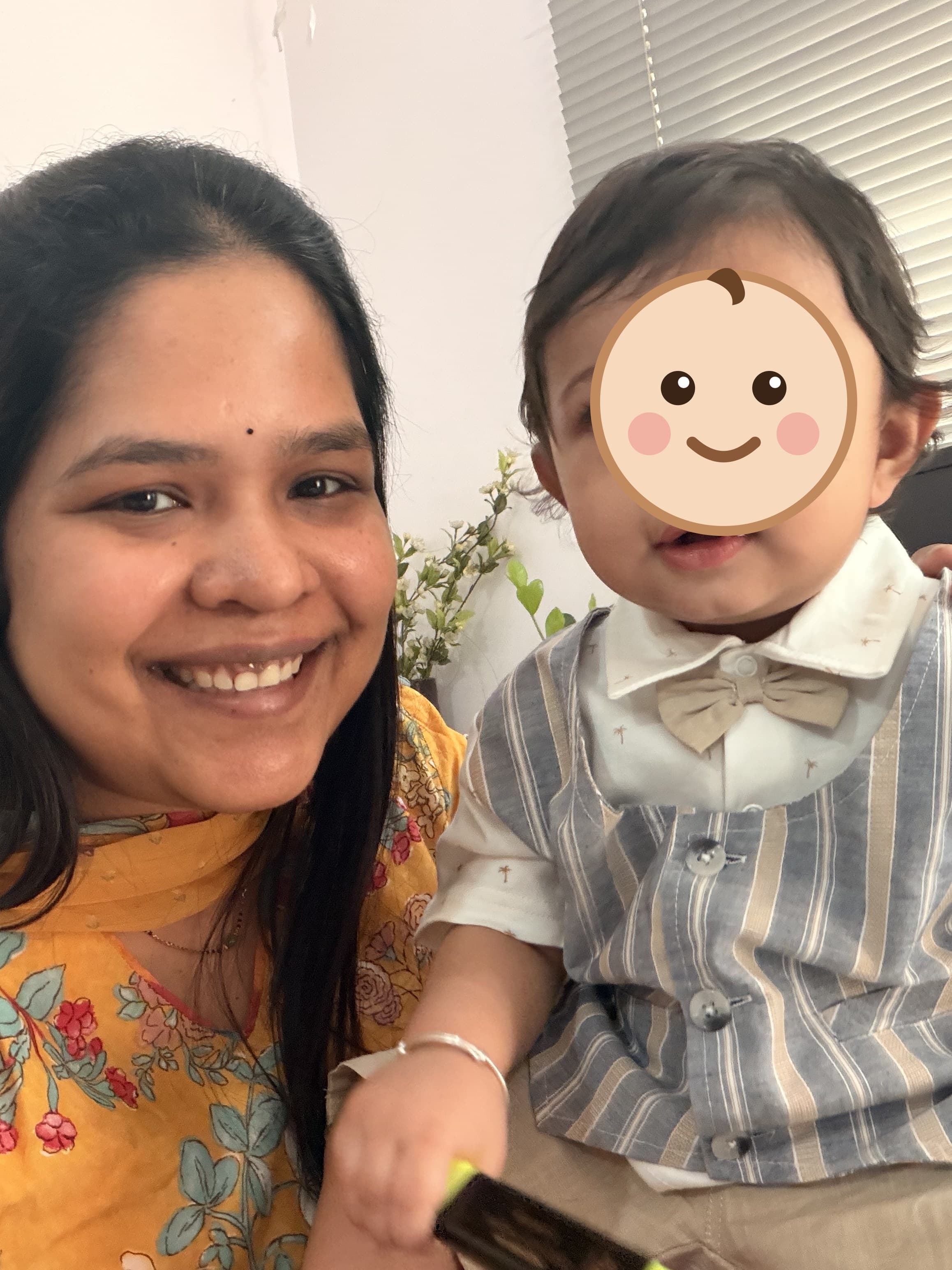 A mother smiling with her toddler son